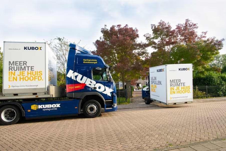 Kubox trailer carrying multiple mobile storage boxes on its way to be delivered to a customer's home